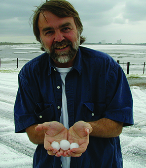 Achtor holding hail stones while storm chasing in 2002.