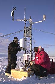 Jonathan Thom (SSEC) works with Douglas MacAyeal (University of Chicago) to put a weather station on iceberg B-15.