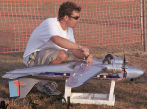 Robert Holz with a DC-3 model airplane, one of many he's made. Holz is also a registered private pilot.