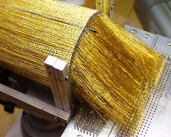 A close-up of the gold wire strung through one of the ADR’s perforated disks. The roll of wire for the project cost $4000.