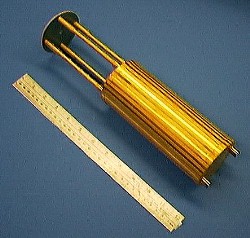 The ADR shown next to a 12-inch ruler. The stripes on the cylinder are alternating rows of gold plate and stainless steel.