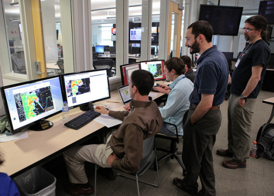 CIMSS scientist John Cintineo stands by while forecasters attending NOAA’s Hazardous Weather Testbed try out the ProbSevere statistical model. The model added at least 10 minutes of lead-time to severe weather warnings more than half of the time at the test-bed this summer. Credit: James Murnan, NOAA.