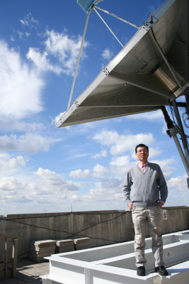 SSEC scientist Jun Li atop UW-Madison's AOSS building. Credit: Sarah Witman, SSEC.