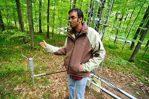 Ankur Desai, associate professor of atmospheric and oceanic sciences at the University of Wisconsin-Madison, talks about an instrument attached to a research tower near Lac Du Flambeau, Wisconsin in 2011. Credit: Bryce Richter, UW-Madison.