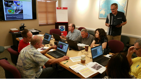 SSEC scientists Scott Lindstrom (standing) and Kathy Strabala (fourth from right) instructing meteorologists at the U.S. National Weather Service forecast office in Guam, 16-19 November 2015. Credit: Jordan Gerth, SSEC.