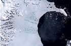 Arial view of an ice shelf extending into the sea